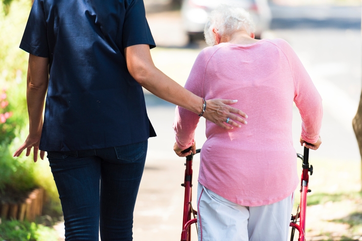 Canterbury Foundation staff providing compassionate care to a resident using a walker