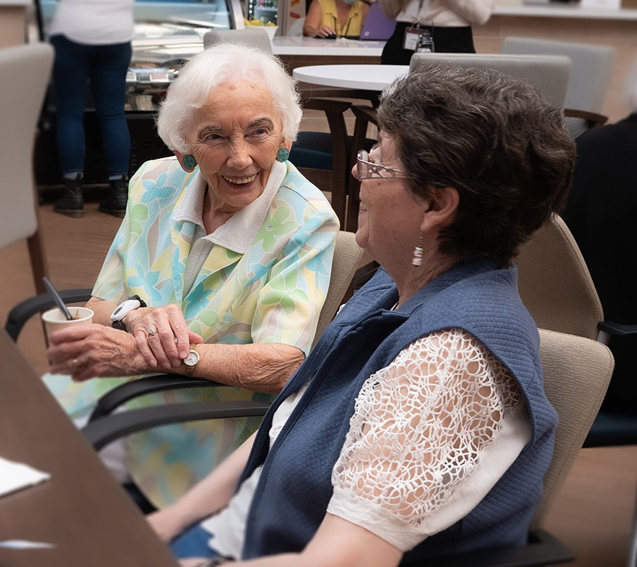 Senior women chatting and smiling at Canterbury Foundation senior housing